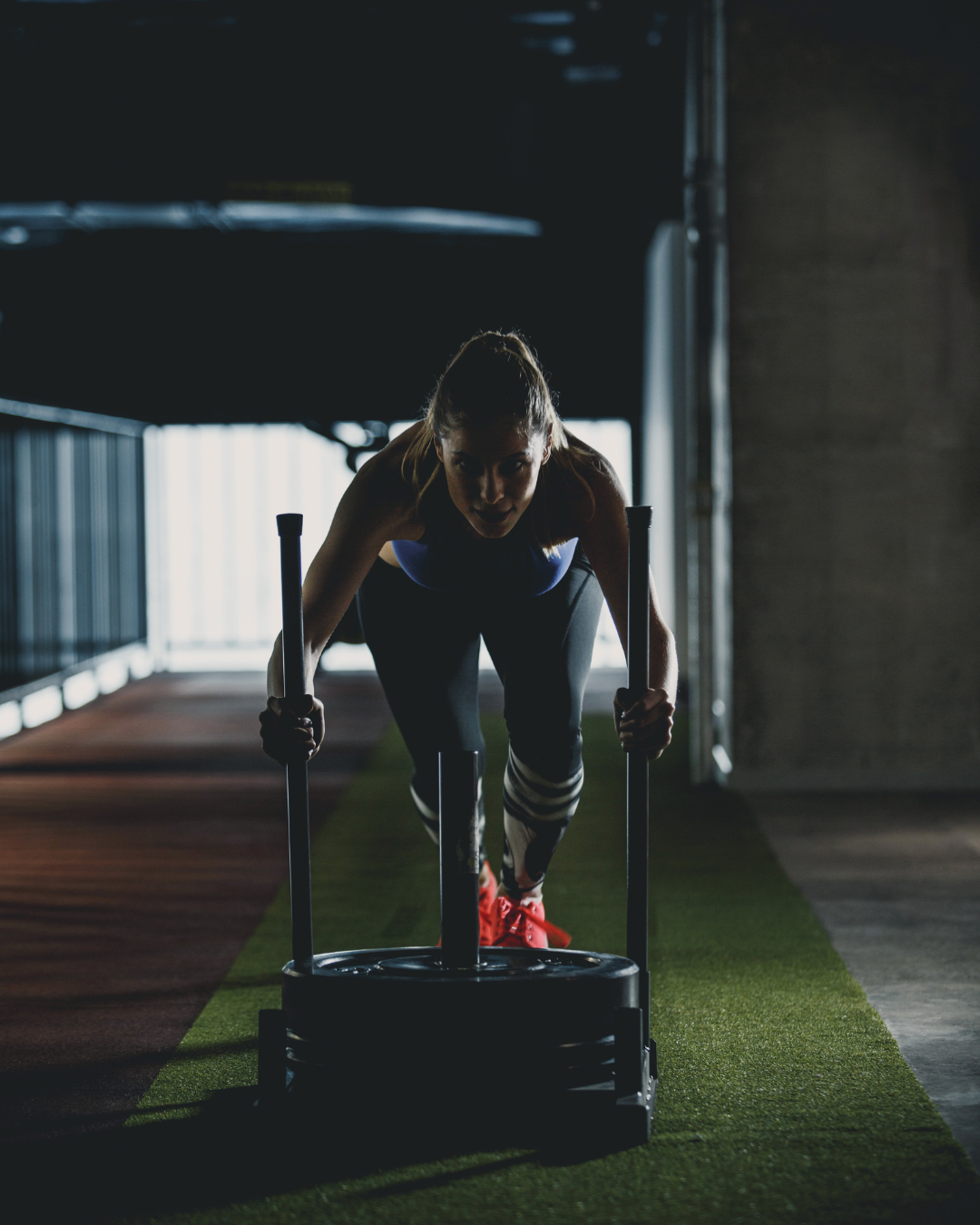 Woman moving a weighted sled